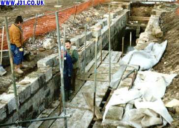 workmen rebuilding lock wall
